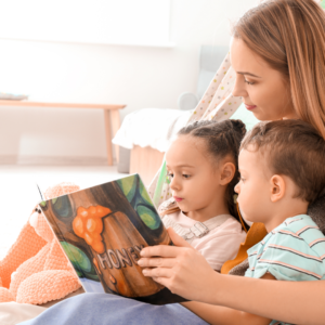 A Mother reading books about sustainability to her two children